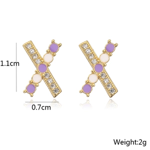 Detail view of 18K gold X-shaped stud earrings with zircon and purple enamel, 1.1cm size