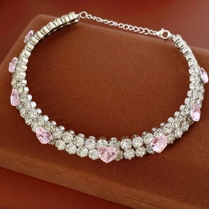 Vue macro du bracelet argenté double rang avec cœur rose et pierres scintillantes
