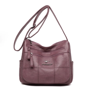 Minimalist purple faux leather crossbody bag with multiple zippers and kangaroo logo