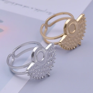 Detail of adjustable open rings in gold and silver with textured fan-shaped relief