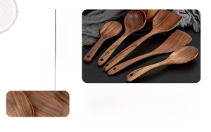 Macro detail of natural acacia wood texture on handcrafted 5-piece kitchen utensil set