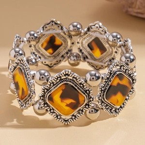 Detail of vintage geometric acrylic stretch bracelet with antique silver finish and tortoiseshell resin