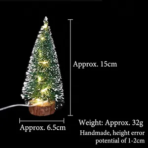 Mini green snowy Christmas tree with LED lights and natural wooden base measuring 15cm height