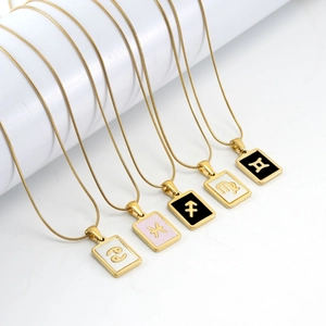 Golden titanium steel zodiac necklaces with shell rectangle pendants on white display