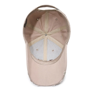 Distressed khaki baseball cap showing interior structure and vintage worn-out brim details
