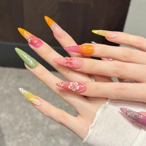 Handmade stiletto press-on nails with summer floral designs and colorful gradients