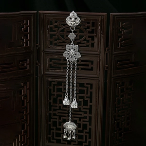 Detail of vintage silver Chinese style bodice brooch with Ruyi lock and lotus elements