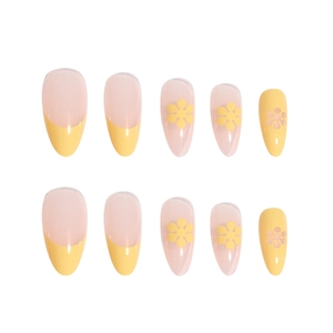 Long almond press-on nails with yellow French tips and small floral designs