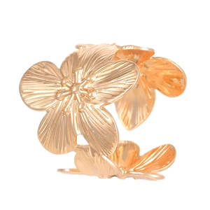 Macro shot of gold floral ring with textured petals and adjustable open band design