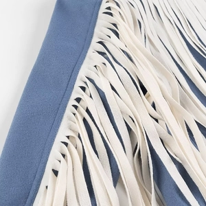 Detail showing white fringe tassels on premium blue suede wool jacket fabric
