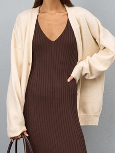 Detailed texture of brown ribbed knit dress and soft off-white cardigan for women