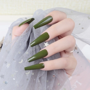 Glossy olive green long coffin press-on nails shown on hand with elegant star pattern mesh