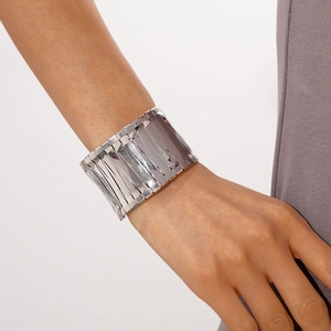 Detail view of a wide polished silver geometric cuff bracelet with mirror finish metal tiles