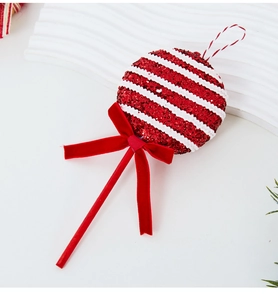 Detail of red and white Christmas candy lollipop with glitter finish and velvet bow