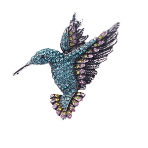 Vintage crystal hummingbird brooch in blue and yellow rhinestones on silver base