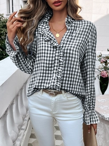 Detail of ruffle collar and button-up black and white plaid shirt for women