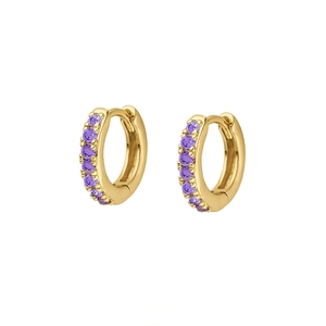 Detail view of 18K gold plated huggie earrings with purple zircon stones on white background