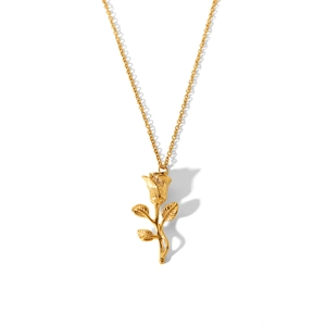 Macro shot of 3D golden rose pendant necklace in polished stainless steel on white back