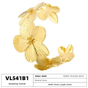Detail view of gold brass floral cuff bracelet featuring textured layered petals