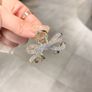 Sparkling rhinestone bow hair claw clip with golden metal finish for cute hairstyle