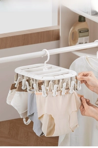 Detail of white 24-clip multifunctional clothes drying rack for socks and baby clothes