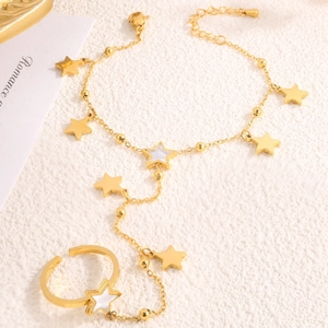 Elegant gold stainless steel star ring bracelet with shell inlay on white texture