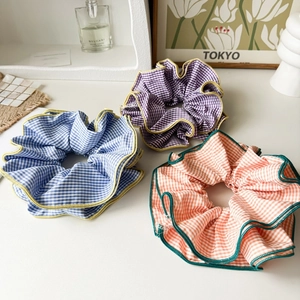 Oversized retro plaid scrunchies in blue, purple and orange colors for ballet style hair