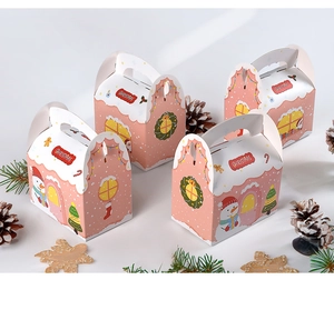 Scatola regalo di Natale rosa a forma di casa con manico e motivo a graffiti