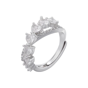 Macro detail of adjustable silver ring featuring five heart-shaped cubic zirconia stones
