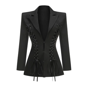 Close-up of black blazer dress with corset-style lace-up detailing and tailored waist