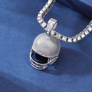 Close-up of silver-tone rugby helmet pendant with tennis chain featuring crystal pavé stones