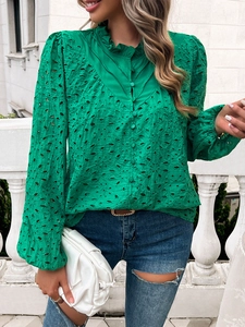 Detail of green hollow lace blouse featuring lantern sleeves and delicate embroidery