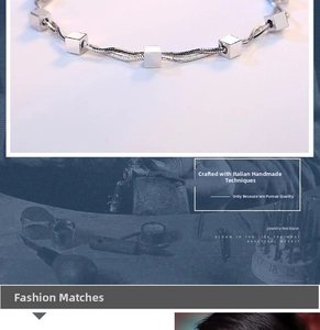 Detail of silver snake chain necklace with cubic zirconia cube pendants and star accents