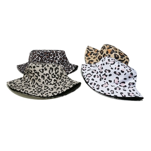 Detail showing four stylish bucket hats in diverse leopard prints on plain white background