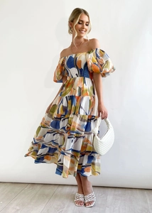 Full view of vibrant bubble sleeve off-shoulder floral maxi dress with layered skirt