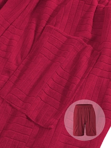 Detail of dark red waffle knit fabric with drawstring elastic waistband on casual shorts