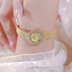 Elegant gold square watch for women with gemstone bezel and metal mesh strap on wrist