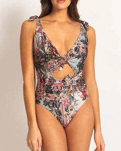 Detail view of floral print swimsuit featuring V-neck and decorative bow tie cut-outs