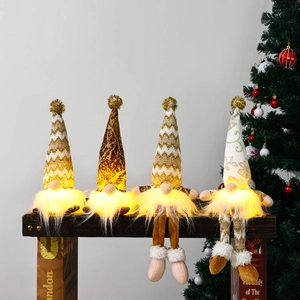 Set of 4 glowing Christmas gnomes with warm LED lights and knit fabric detail on wooden stand