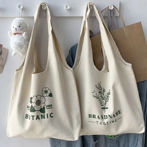Close-up of durable cream canvas tote bag featuring vintage green botanical floral prints