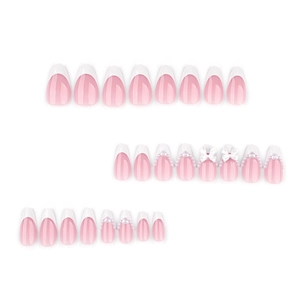 Pink French almond press-on nails set with white bows, pearls, and heart charms