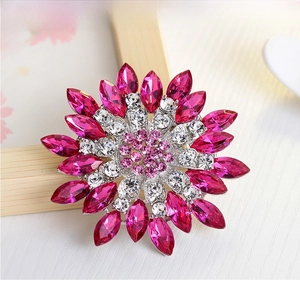 Macro detail of crystal flower brooch with vibrant pink and clear sparkling rhinestones