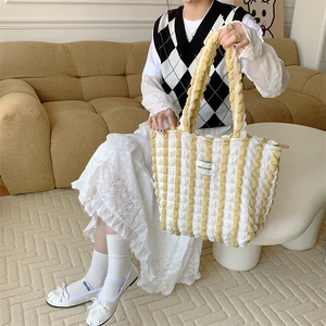Detail of yellow popcorn texture tote bag with LOVE SOZAKKA label and stripe design