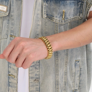 Close-up of a 15mm gold-plated stainless steel watch band bracelet on a male model's wrist