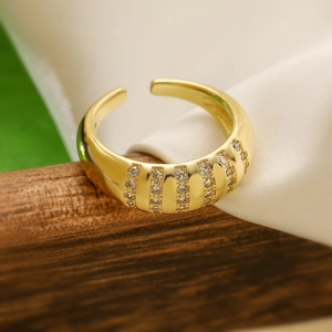 Macro shot of gold plated geometric ring with six rows of micro-inlaid zircons