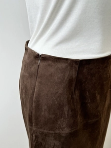 Detailed view of the dark brown suede skirt waistline featuring a seamless hidden zipper