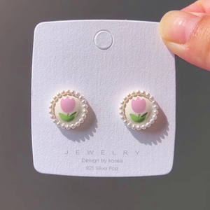 Detail of pink tulip earrings with pearl bead border and 925 silver needles