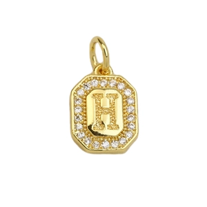 Close-up of golden letter H pendant with shimmering square-set cubic zirconia stones