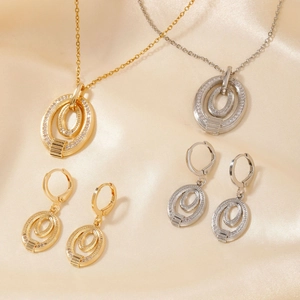 Elegant gold and silver oval jewelry set with micro-inlaid rhinestones on beige silk