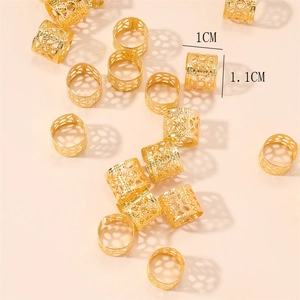 Detail of 1cm x 1.1cm golden hollow cylinder hair rings for braids and dreadlocks
